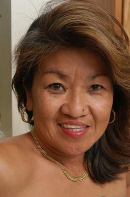 Mature Asian Dottie gets naked in her kitchen.