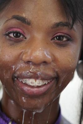 Les femmes ébène prennent des soins du visage giclants et collants